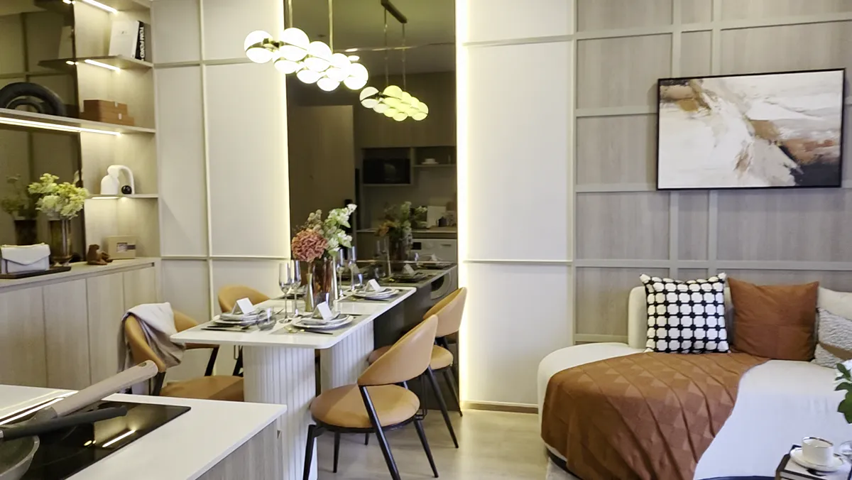A residence living area with a curved sofa and a dining table.